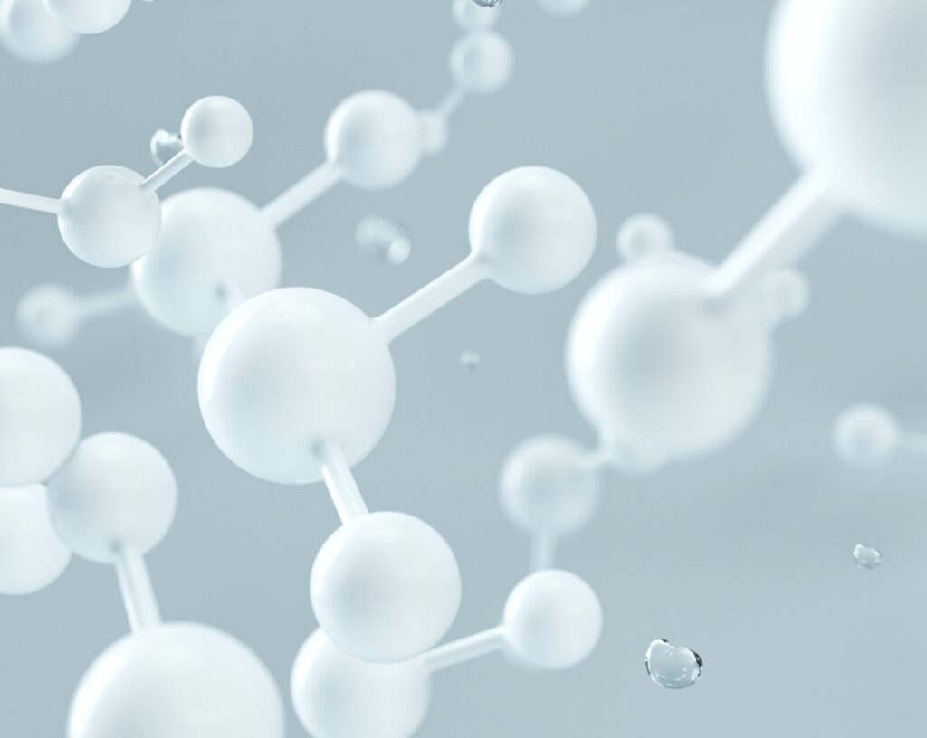 White glossy spheres linked by short rods forming a stylized molecular model floating on a pale blue background.
