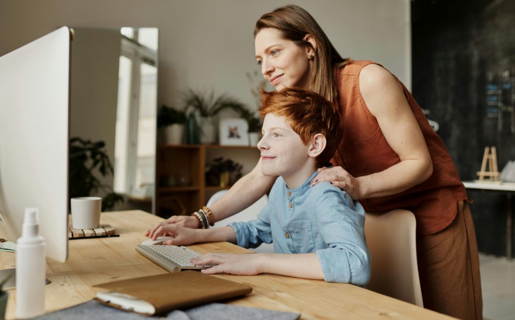 Children and parent in front of a computer